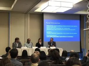 Panelists Horton, Lall, Orff and Pawlowski sitting in front of an audience for a panel discussion.