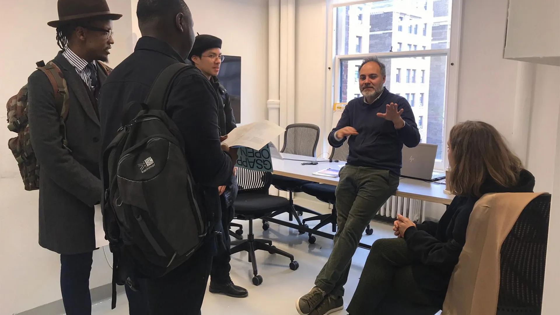 Four prospective students from the GSAPP open house listening to Thaddeus Pawlowski at the CRCL office.