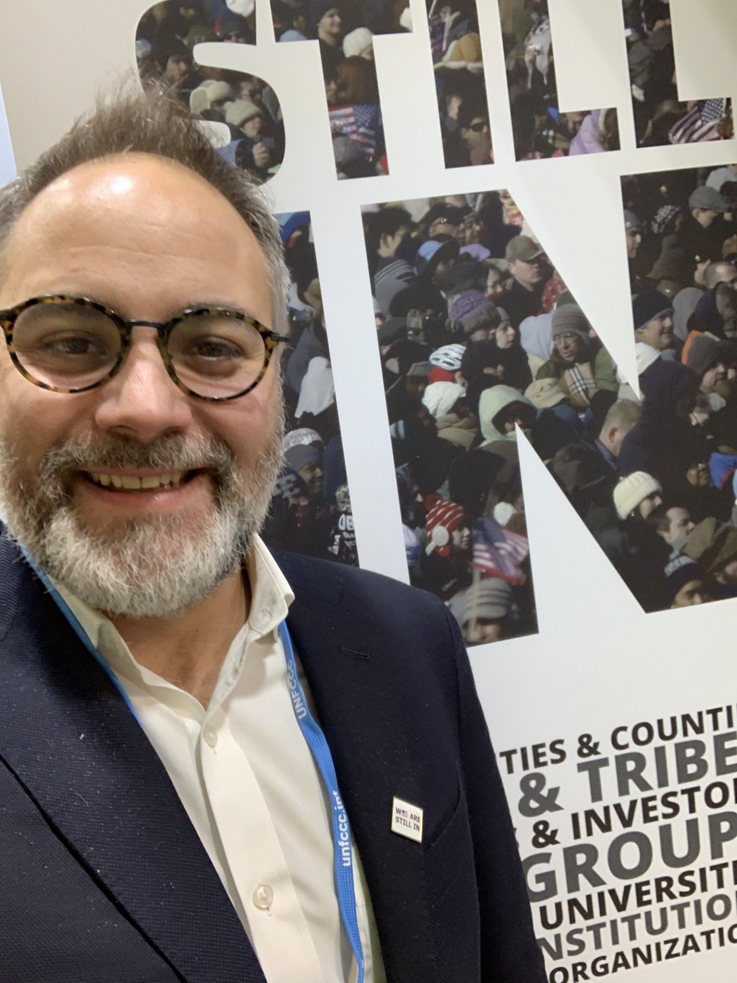 Thad Pawlowski, Director at CRCl, in front of the "We Are Still In" tent "
